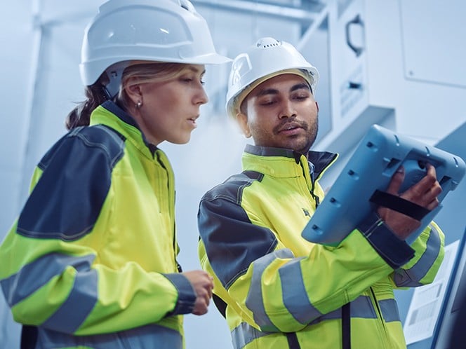 worker checking tablet at plant
